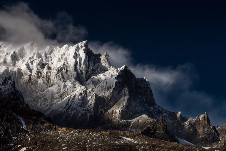 Sunlight on rugged, snow-covered mountain peaks